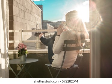 Woman Drinking Coffee Under Sun, Outdoor On Balcony With City View