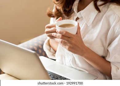 Woman drinking coffee and using digital tablet in the morning - Powered by Shutterstock