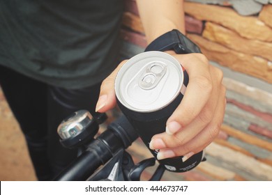 Woman Drinking Cola Can With Bike