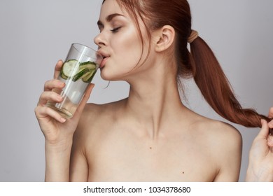 Woman Drinking Cucumber Water        