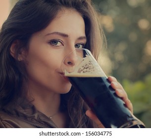 Woman Drinking Dark Fresh Beer Outdoor And Enjoying. Closeup Vintage Portrait