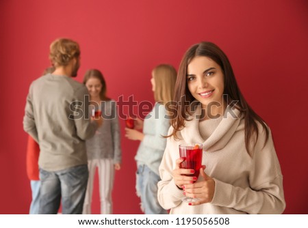 Woman drinking delicious mulled wine at party