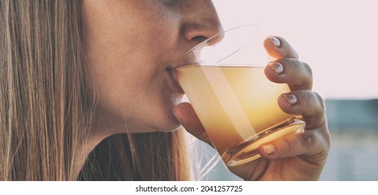 Woman Is Drinking Dirty Water From The Glass Cup

