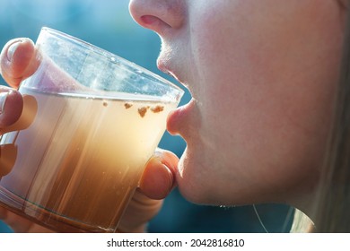 Woman Is Drinking Dirty Water From The Glass Cup
