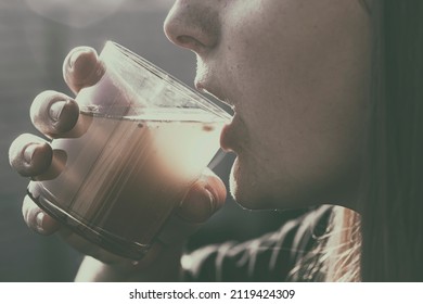 Woman Is Drinking Dirty Water From The Glass Cup
