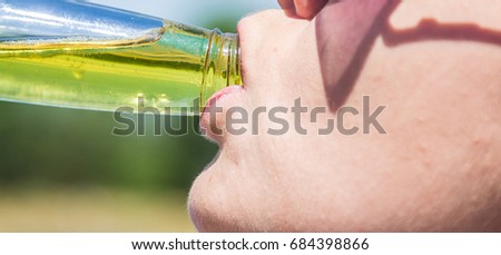 A woman is drinking an energy drink