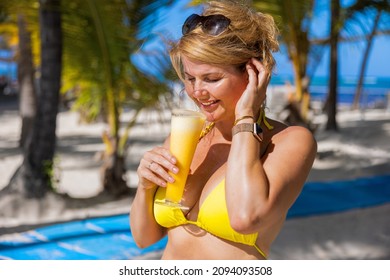 Woman Drinking Fresh Fruit Cocktail On Tropical Beach