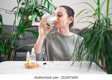 Woman Drinking Glass With Chlorophyll Water, Antioxidant Beverage. Healthy Lifestyle 