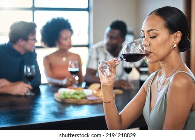 A Woman Drinking A Glass Of Wine At A Dinner Table With Friends In A Restaurant And Enjoying The Luxury Alcohol. Young African American Female Having Fun Dining With People At A Celebration