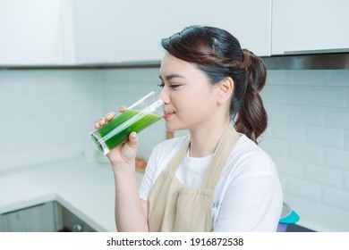 Woman Drinking Green Detox Juice, Smoothie Drink In Kitchen Portrait. 