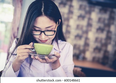 Woman Drinking Green Tea In Cafe