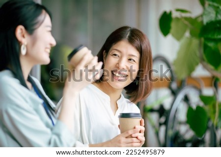 Woman drinking hot drink and chatting