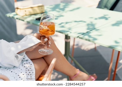 Woman drinking iced summer cocktail aperol spritz - Powered by Shutterstock