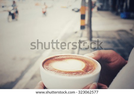 Woman drinking latte art coffee