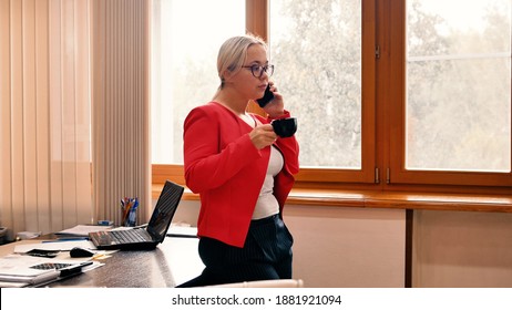 A Woman Is Drinking Morning Coffee In Her Office. Slow Motion