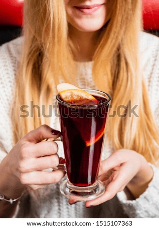 woman drinking mulled wine in the cafe
