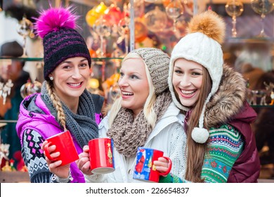 Woman Drinking Mulled Wine In Mug On German Christmas Market