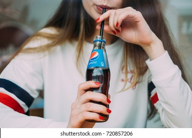 Woman drinking pepsi in the bar