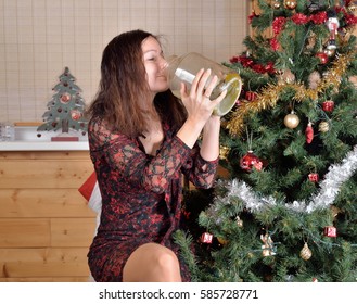 Woman Drinking Pickle Juice From The Jar At The Christmas Tree.