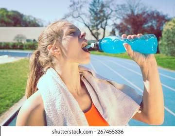 woman drinking power drinking after long run. concept about sport