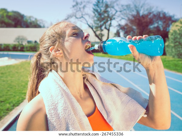 woman drinking power drinking after long run.\
concept about sport