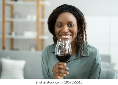 Woman Drinking Red Wine In Video Conference At Home