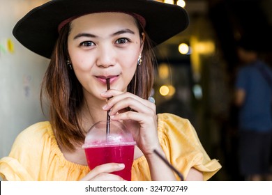 Woman Drinking Soda In Plastic Cup By Straw