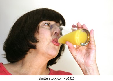 Woman Drinking Some Orange Juice.