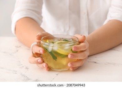 Woman Drinking Tasty Cold Ice Tea At Table