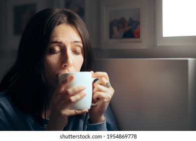 Woman Drinking Tea For Insomnia Sitting In Her Bedroom. Sleepy Young Person Having A Calming Homeopathic Herbal Beverage Before Sleep 
