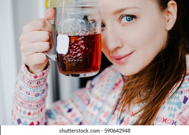 Woman Drinking Tea With Lemon. Sweet Drink