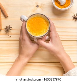 Woman Drinking Turmeric Latte On Golden Almond Or Coconut Milk, Healthy Drink, Low Carb Diet, Sugar Free, Dairy Free Drink, Wooden Background