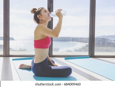 Woman Drinking Water After Yoga