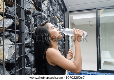 woman  drinking water from bottle