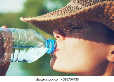 Woman Drinking Water In Summer Sunlight