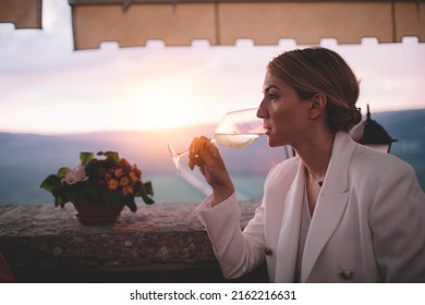 Woman Drinking White Wine At Winery