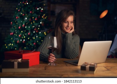 Woman Drinking Wine, Using Laptop, Shopping Online. Christmas Tree In The Background.