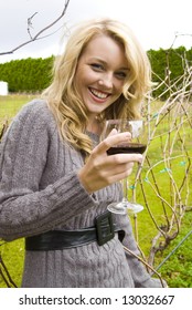 Woman Drinking Wine At The Vineyard