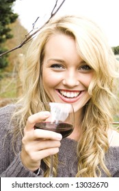 Woman Drinking Wine At The Vineyard