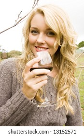 Woman Drinking Wine At The Vineyard