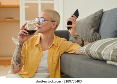 Woman Drinking Wine While Talking On Phone