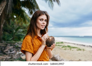 A Woman Drinks Coconut Juice In Nature On The Island