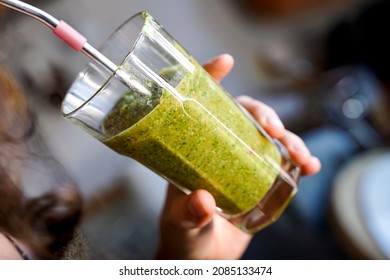 A Woman Drinks A Green Smoothie Fruit Shake Using A Metal Straw.