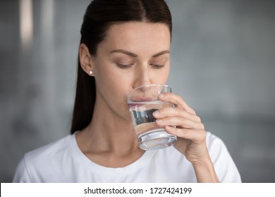 Woman Drinks Still Water Close Up Portrait. Quench Thirst, Water Balance And Weight Control, Caring Of Skin And Body, Hangover Relief, Body Refreshment, Energy Recovery, Dehydration Prevention Concept