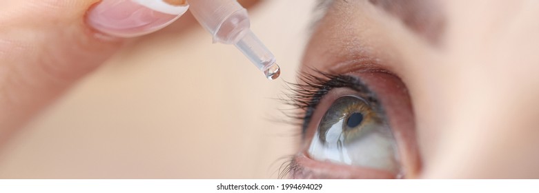 Woman drips eye drops into her eyes - Shutterstock ID 1994694029