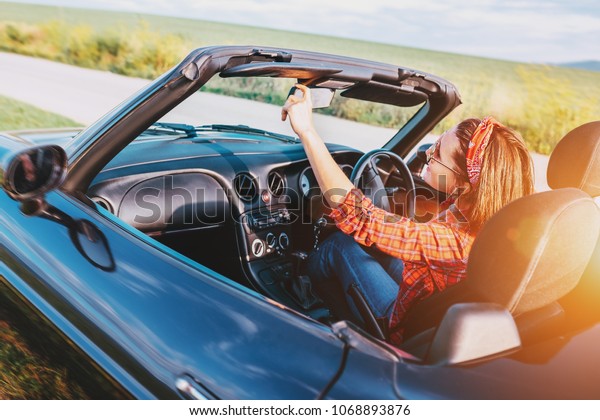 Woman drive a cabriolet\
car