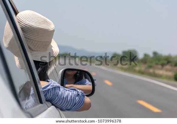 Woman drive a car\
on the road with a\
mountain