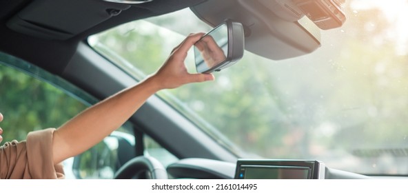 woman driver adjusting rear view mirror a car. Journey, trip and safety Transportation concepts