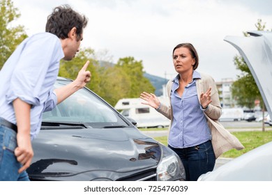 Woman Driver And Angry Man Arguing About The Damage Of The Car 