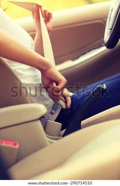 woman\
driver buckle up the seat belt before driving car\
